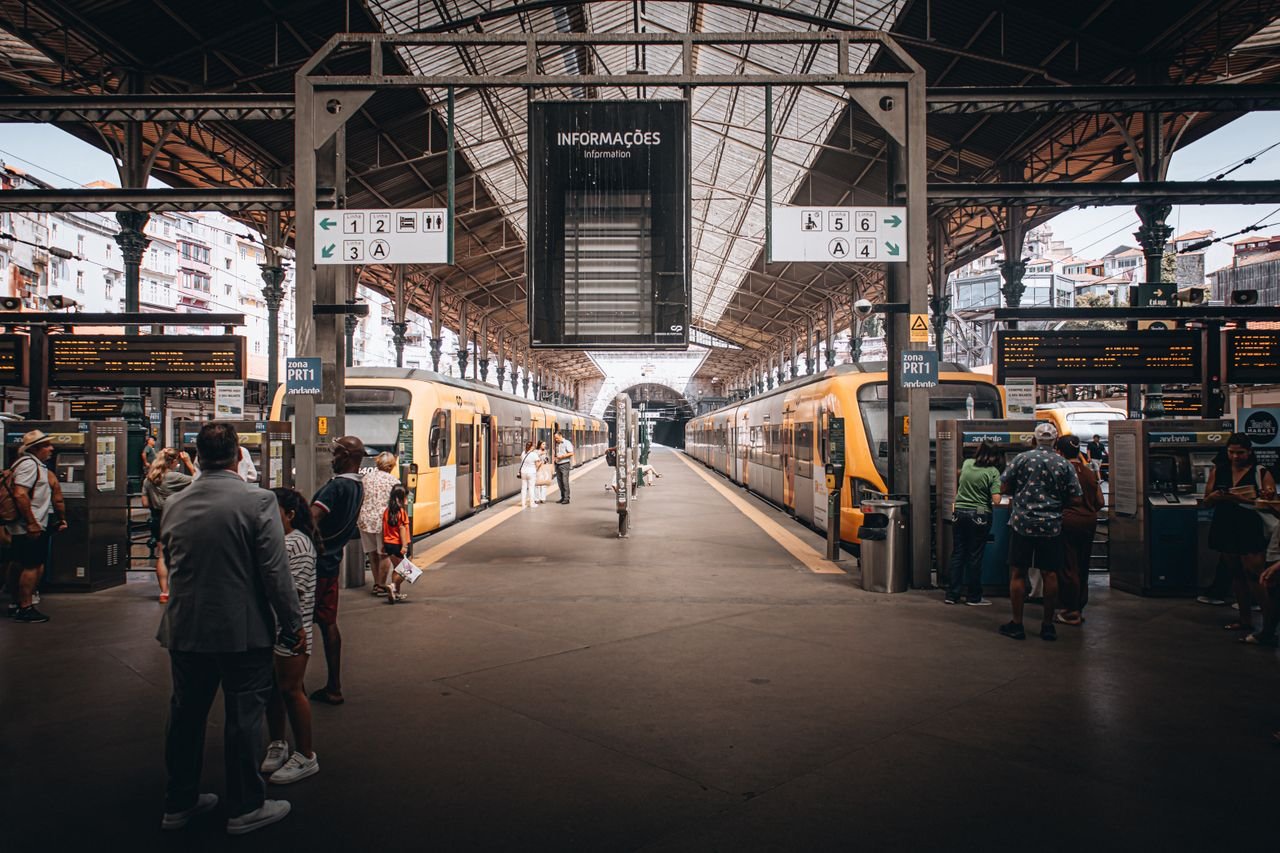 Mastering the First Impression: Your intriguing post title goes here Vibrant scene of a busy urban train station with travelers and two trains.